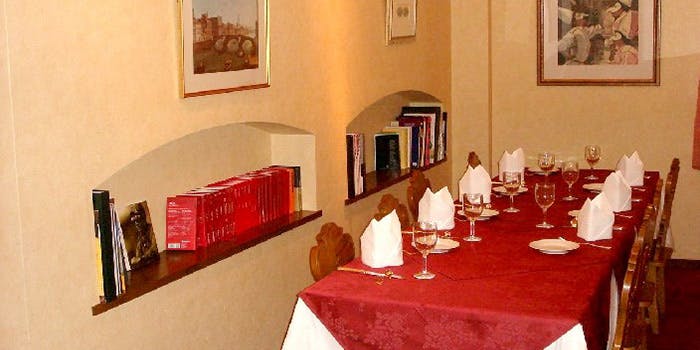 白を基調としたクラシカルな店内に、赤いテーブルクロスが敷かれた客席がセッティングされている。